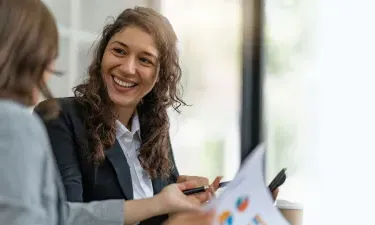 Project manager with bachelor's degree smiling during meeting